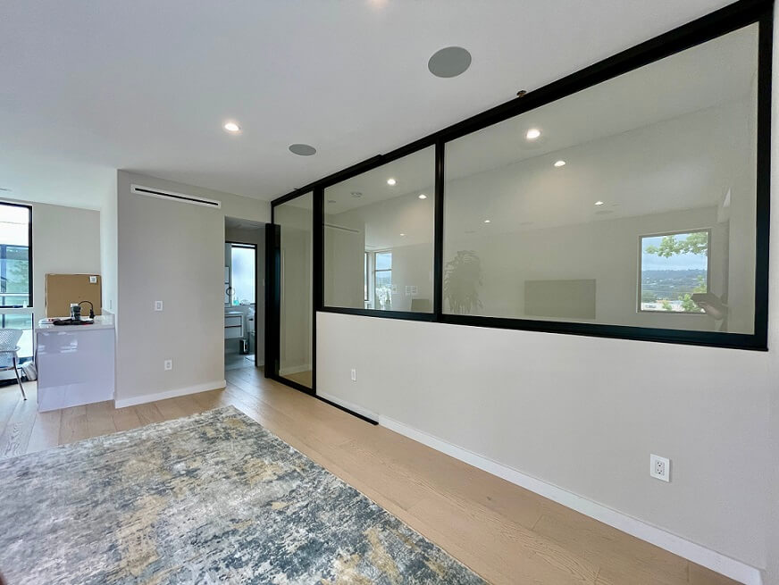 Modern interior with glass doors and hardwood floors.