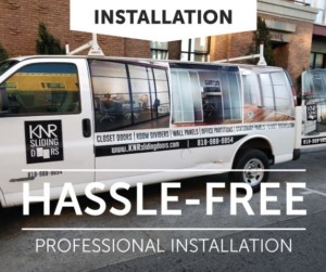 A commercial van wrapped with advertising for professional glass doors and interior doors installation services, promoting a hassle-free experience.