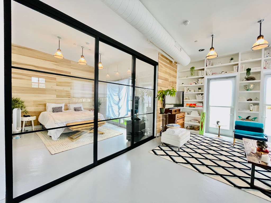 Glass room divider between living room and bedroom