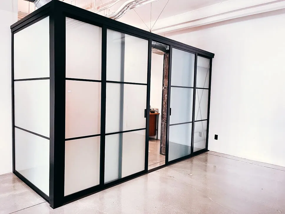 Black-framed room divider with frosted glass and horizontal beams