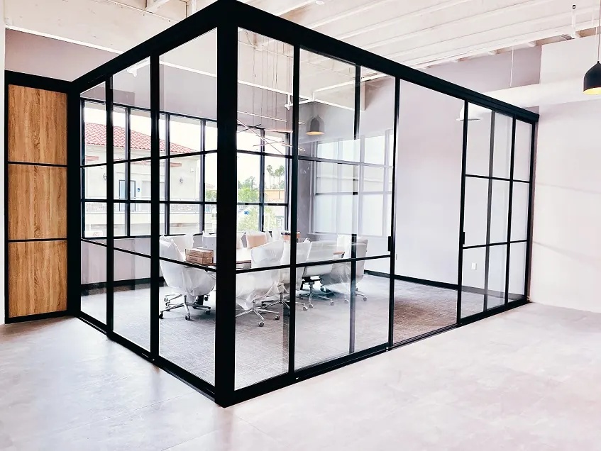 L-shaped glass office enclosure with fixed panels