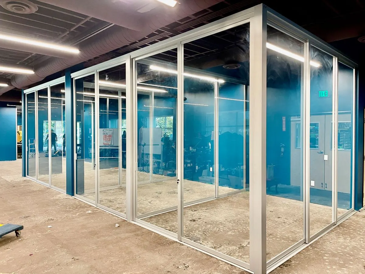 Clear glass office partition with silver metal frame